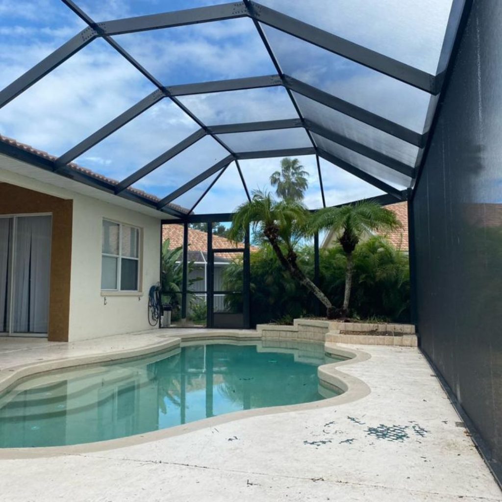 a screen around an outdoor pool